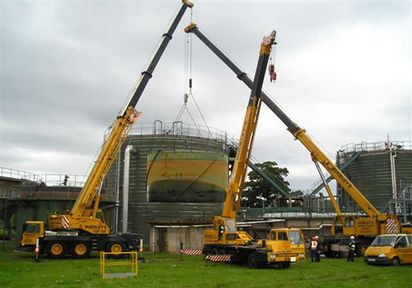 Several Cranes Moving a Container